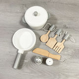 The 8 piece wooden accessories include 4 implements, a salt and pepper pot, a frying pan and casserole pan