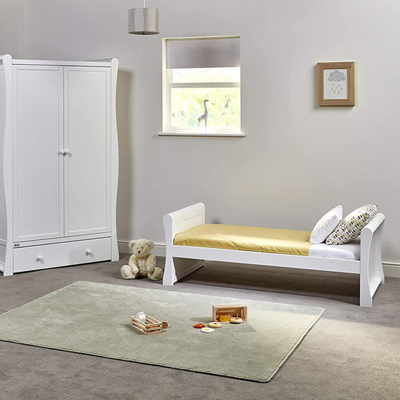 This White Wooden Sleigh Shaped bed is low to the floor, to make sure your toddler is safe getting in and out of bed by themself.