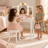 Two girls playing dress-up at a white LED vanity table with crown mirror and stool