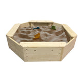 Wooden sandbox with sand and toys on a white background