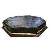 Black octagonal sandpit cover on a white background