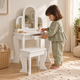 White children’s dressing table with triple arched mirror and matching stool in a neutral bedroom