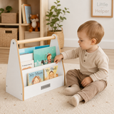 Child choosing a book from white Montessori bookshelf