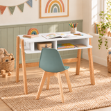 White children’s desk with a green padded chair in a playroom