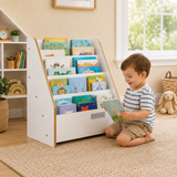 Toddler choosing a book from Montessori bookcase