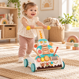 18 month old girl pushing adjustable wooden baby walker in Little Helper playroom