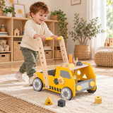 Three-year-old boy pushing wooden activity walker in a playroom