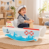 Toddler dressed as a sailor playing in wooden nautical rocking boat