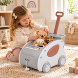 Young girl playing with teddy bears in push and pull toy storage cart