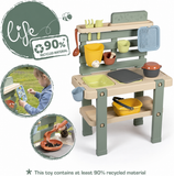 Mud kitchen with cooking and gardening accessories