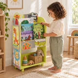 Four-year-old girl choosing a picture book from a colourful safari bookcase.