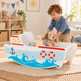 Three year old boy enjoying wooden rocking ship in Little Helper playroom