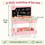 Pink wooden toy workbench measuring 50 × 29 × 73 cm