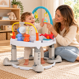 Mum playing with baby in musical activity centre in neutral nursery