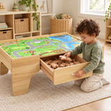 Child taking wooden railway tracks from the train table’s storage drawer.