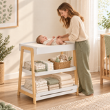 White baby changing table with natural wood coloured legs
