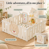 Toddler exploring the interactive activity panel in a cream deer baby playpen