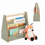 A wooden children's book organizer with a light sage green frame and natural wood handle