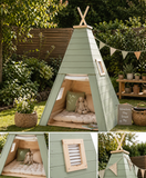 Sage green wooden teepee playhouse with floor, kids garden play tent, outdoor wooden playhouse with cushions in summer garden