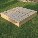 wooden sandpit with bench seating
