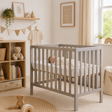 Compact wooden baby cot in warm grey for small nursery