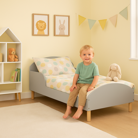Grey toddler bed with pine legs and safety side panels