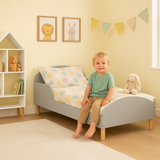 Grey toddler bed with pine legs and safety side panels