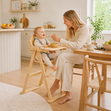Baby girl in eco beech wood high chair with activity toy