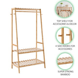 Bamboo clothing rack with shelves and hooks on a white background