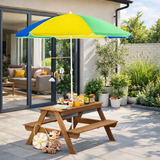 Children's wooden picnic table with a colourful umbrella in a garden setting.