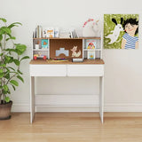 White desk with wooden top in a room with a plant and wall art.