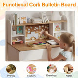 Child interacting with a cork bulletin board on a desk, surrounded by educational materials.