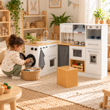 little girl loading washing into her pretend toy kitchen washing machine