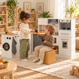 little girl and boy sharing a coffee moment with their pretend toy kitchen