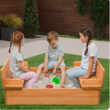Three Children playing in a wooden sandpit outdoors