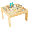 Tooky Toy wooden train table with pastel trains and teal bridge in a neutral playroom.