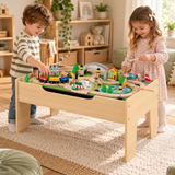 Two children enjoying the wooden railway table with train play and magnetic fishing.