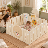 Baby playing with pit balls inside a cream playpen with included play mat