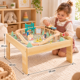 - Tooky Toy wooden train table dimensions, 59 × 60 × 39 cm, with a three-year-old girl playing.