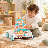 18 month old boy exploring cake-themed wooden walker activity panel