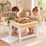 Kids drawing on a reversible blackboard activity table in a neutral playroom