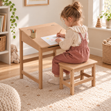 Natural children’s desk and matching stool with angled desktop in a neutral Little Helper playroom.