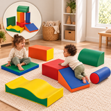 Two toddlers exploring a blue climbing ramp and green mat beside colourful foam blocks