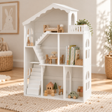 Large white wooden dolls’ house bookcase displaying books and toys in a neutral playroom.