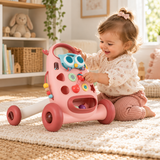 Toddler girl playing with sensory activities on pink Montessori baby walker