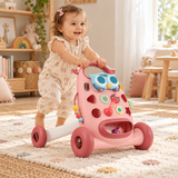 One year old girl pushing pink Montessori activity walker in nursery playroom