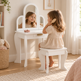 Three-year-old girl brushing her hair at a white children’s dressing table