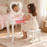 Three-year-old girl playing at a heart mirror dressing table in a neutral bedroom