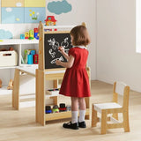 Child in a red dress drawing on a blackboard in a playroom with toys and furniture.