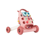 Pink baby walker with colorful buttons and an owl design on a white background